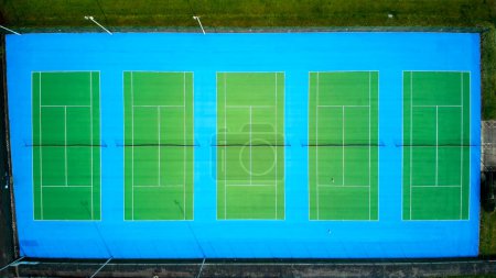 Tennis courts aerial view. Distinct blue and green coloured tennis courts in a line. 