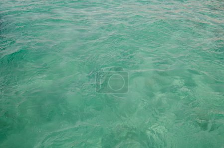 Photo for Sea water surface as green background.  Water is not clear, you can see glare. - Royalty Free Image
