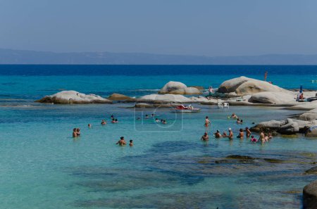 Photo for Mega Portokali Beach 08-05-2023 Greece, Halkidiki, Sithonia. People swim in azure bay. There are white boulders in background. Horizon, sky. - Royalty Free Image