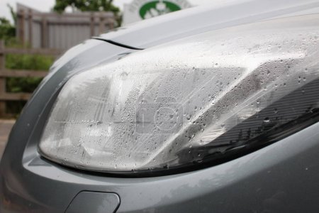 Foggy headlight with condensation in a modern car up close perspective