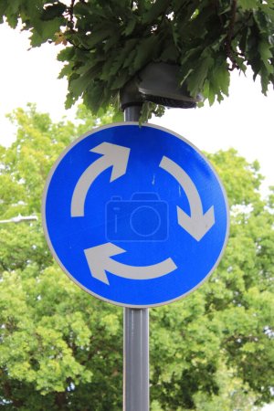Mini round about sign white arrows with blue background UK