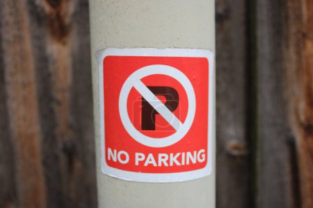 Photo for Red No Parking sticker attached to a lamp post - Royalty Free Image