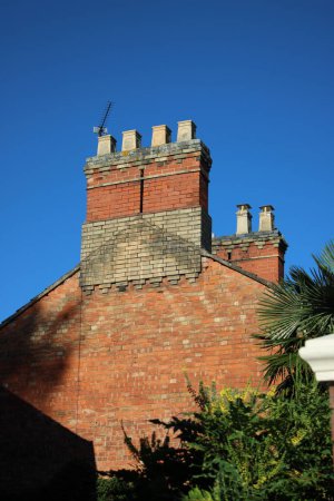 Photo for Chimney stack with 4 chimneys, Clear blue sky in background - Royalty Free Image