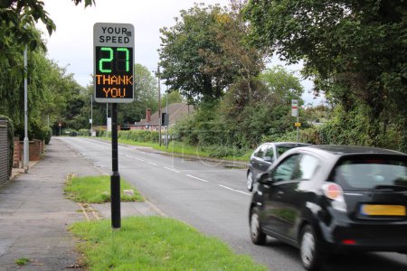 Vehicle activated speed sign displaying speed to driver, sign showing drivers speed 27 MPH Thank you