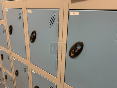 Side view of several blue and silver lockers, taken indoors