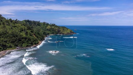 Photo for A stretch of big waves and a beach that directly faces the open sea, Jolosutro Beach, Indonesia - Royalty Free Image