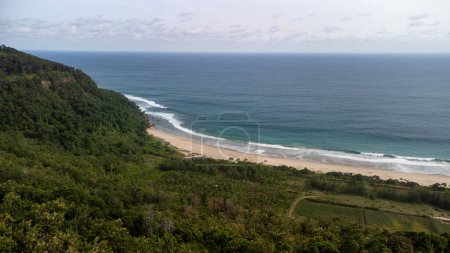 Foto de Un lado de la playa de Mondangan se puede ver en colores azules y verdes del mar, arena blanca, y cerca de los bosques tropicales - Imagen libre de derechos
