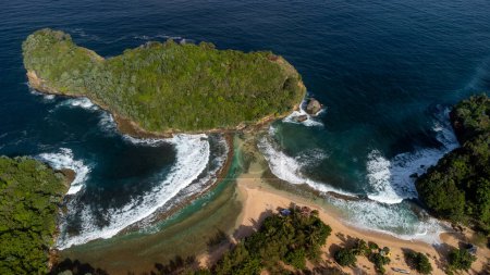 Photo for It's really beautiful, the curved shoreline is connected to a small island in the shape of a woman being bent. Location at Batu Bengkung Beach, Java Island - Indonesia. - Royalty Free Image