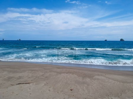 Photo for Jolangkung beach, with blue beach water, blue sky, and slightly yellow sand - Royalty Free Image