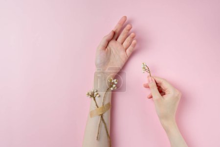 Creative beauty photo hand girls with flowers on pastel pink background