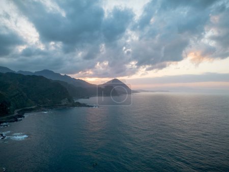 Photo for Aerial view of sunset at Bitoujiao lighthouse, a famous scenery of Taiwan northeast corner. Birds eye view in Bitoujiao cape, Ruifang district, New Taipei, Taiwan. - Royalty Free Image
