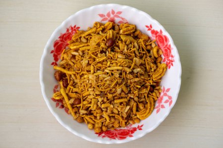 Classic mixed Chanachur and nuts on a floral white bowl, top view