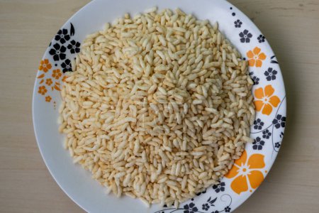 Puffed rice on a decorated floral white melamine plate. Top view. Locally known as Muri in Bangladesh.