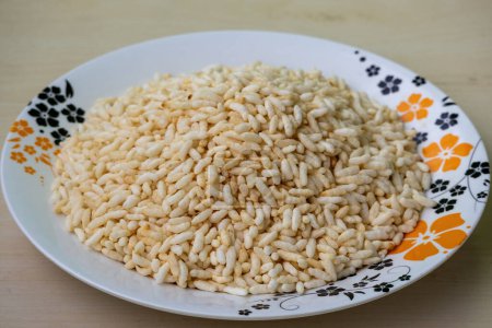 Puffed rice on a decorated floral white melamine plate. Locally known as Muri in Bangladesh.