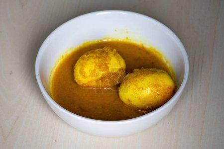 Egg curry in a white bowl. Delicious boiled egg masala curry with coconut. 