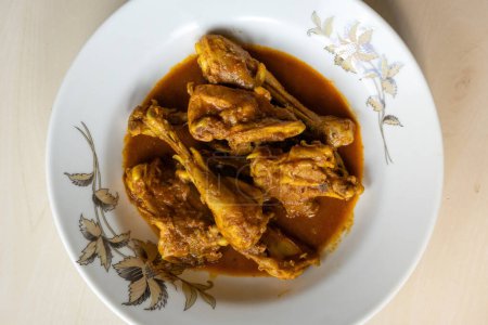 Chicken curry serving on a white plate. Deliciously cooked chicken recipe. Asian food.