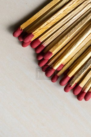 Match sticks on a wooden textured background. Matchsticks are very useful for starting a fire, lighting a candle, burning paper, etc.