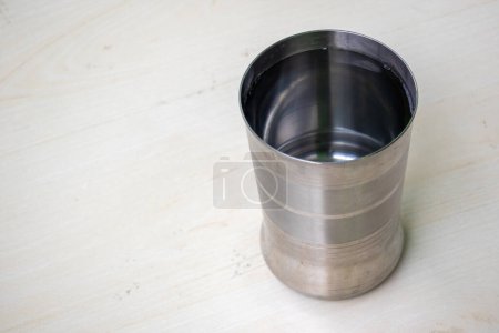 Photo for A stainless steel glass filled with fresh drinking water on wooden surface - Royalty Free Image