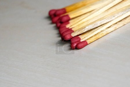 A pile of match sticks isolated on a wooden surface