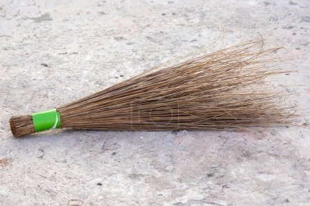 Coconut leaf stick broom. It is a traditional broom that is widely used in rural areas of Bangladesh. It is made of dried coconut tree leaves stick. Locally in Bangladesh, it is called Sholar Jharu
