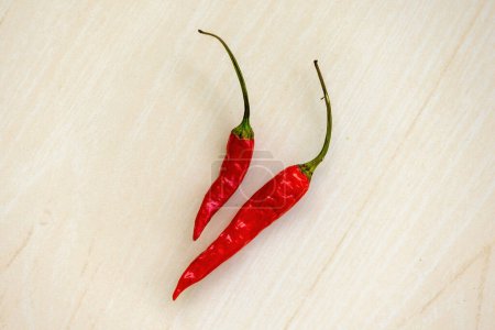 Red hot chili peppers on wooden background. 