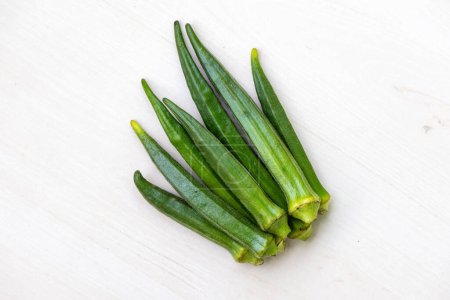 Fresh green vegetable okra or lady's finger isolated on white background. Healthy vegetables for cooking.