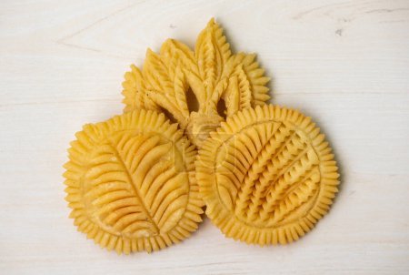Decorated Nakshi Pitha or Pakkon Pitha is a type of pitha made from rice flour. It is traditional food from Bangladesh. Various designs are made on the body of this pitha.