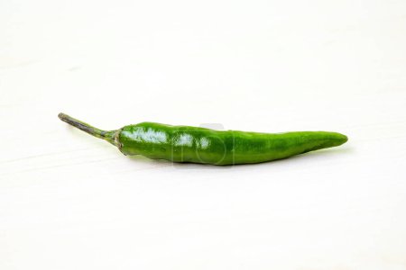 Fresh green hot chili pepper on a white background.