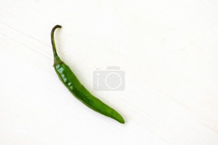 Fresh green hot chili pepper on a white background. Top view