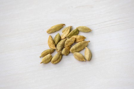 Cardamom seeds isolated on a wooden background. Its scientific name is Elettaria cardamomum. It is also known as Elachi.Top view.