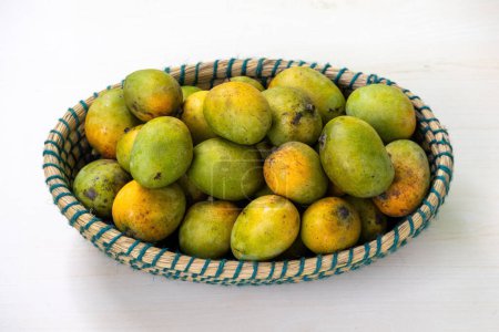 Fruit basket full of ripe mangoes. A wicker basket full of fresh ripe mangoes.