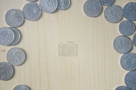 Indonesian money coins on wooden background