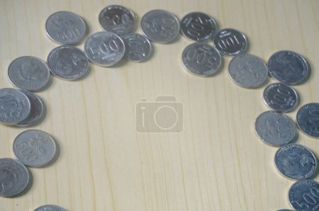 Indonesian money coins on wooden background