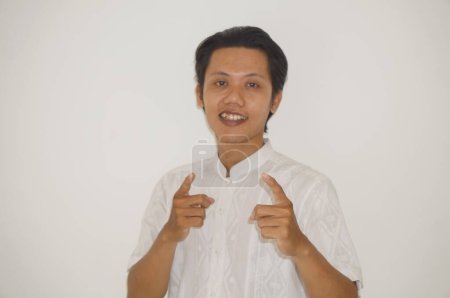 Photo for Young asian man wearing white shirt happy and smiling by pointing at camera - Royalty Free Image