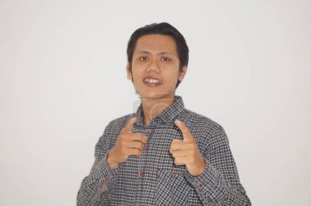 Photo for Young asian man wearing black shirt happy and smiling by pointing at camera. - Royalty Free Image