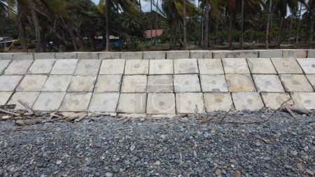 Photo for Wave breakers are arranged on the coast in the form of neatly arranged cubes made of concrete - Royalty Free Image