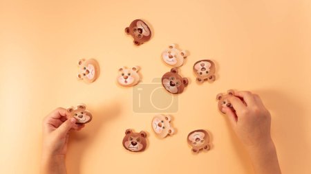 Photo for Little girl hands playing with eco game. Game for visually displaying emotions, ssensory processing disorder, activities Montessori. High quality photo - Royalty Free Image