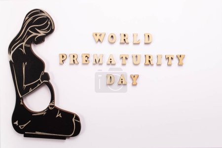 Photo for World Prematurity day concept. Banner with the inscription in wooden letters and pregnant woman.. - Royalty Free Image