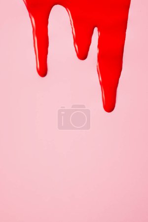 Blood on pink background. First menstrual period concept, menstruation cycle period, menstruation cycle period.