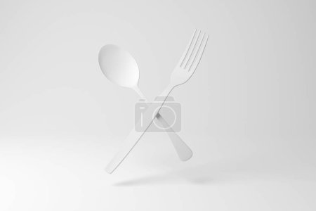 Téléchargez les photos : Fourchette blanche et cuillère flottant en l'air sur fond blanc en monochrome et minimalisme. Illustration du concept de coutellerie, gastronomie, chefs et restaurants - en image libre de droit