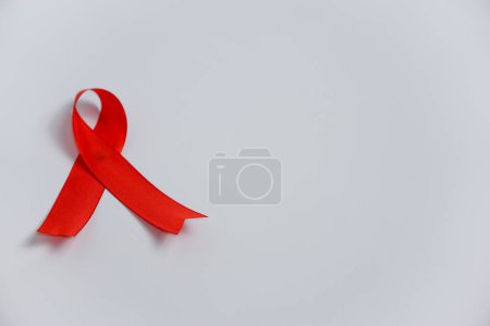 rote Bänder zur Unterstützung des Konzepts des Welt-AIDS-Tages und des Monats des HIV / AIDS-Bewusstseins.