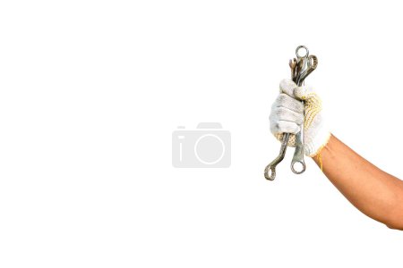 Téléchargez les photos : Mains portant des gants tenant une clé à bague, bonne journée de travail. Fête internationale. - en image libre de droit
