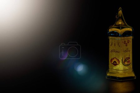 Ramadan Kareem greeting photo with a black background and calm light with beautifully shining lanterns.