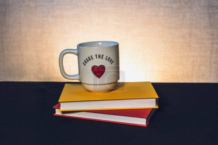 Photo for Mug with a book the theme of learning or creating a postcard - Royalty Free Image