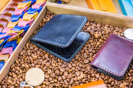 Photo for Soft tone leather wallet with coffee on a wooden table - Royalty Free Image