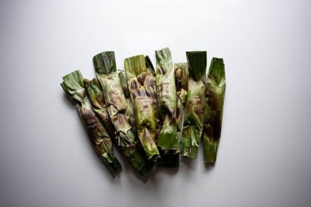 Photo for Otak-otak - Traditional food from Indonesia is a kind of snack - grilled fish cakes wrapped with banana leaf - Royalty Free Image