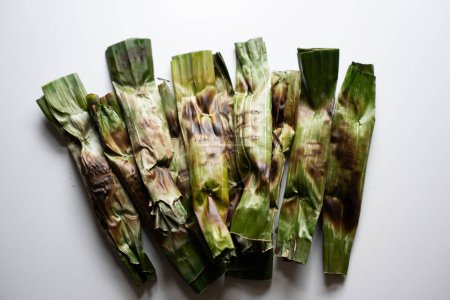 Photo for Otak-otak - Traditional food from Indonesia is a kind of snack - grilled fish cakes wrapped with banana leaf - Royalty Free Image