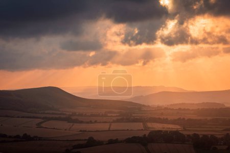 Photo for Waiting for sunset over Firle beacon from Wilmington Hill on the south downs east Sussex south east England UK - Royalty Free Image