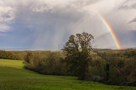 Photo for Rainbow over Brightling park on the high weald in east Sussex south east England UK - Royalty Free Image