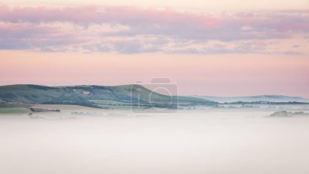 Photo for Misty morning sunrise from Wilmington Hill on the south downs east Sussex south east England UK - Royalty Free Image